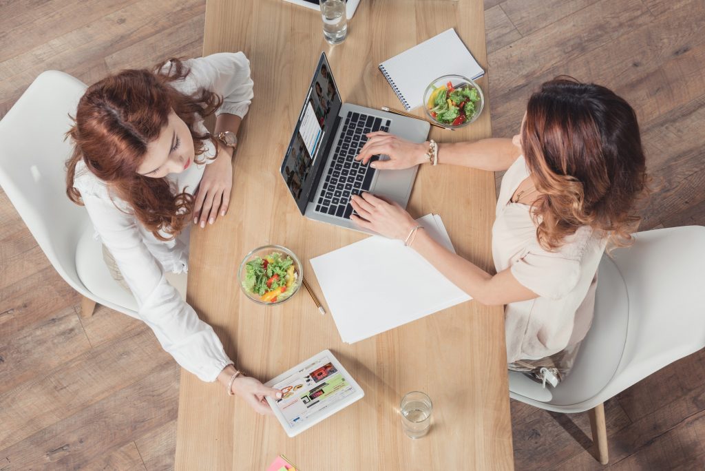 top view of women having salad together while talking about linkedin networking